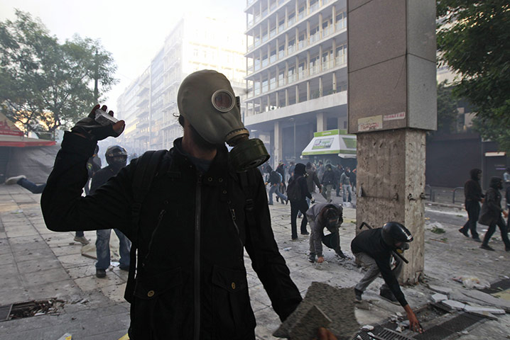 Greece strikes & protests: Protesters throw stones at Greek police officers during clashes in Athens