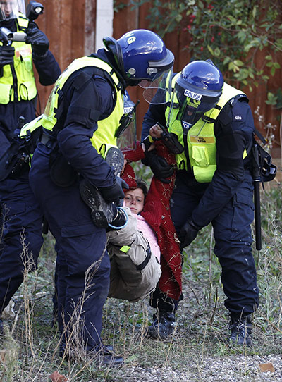 Dale Farm: A supporter is carried away by police during evictions