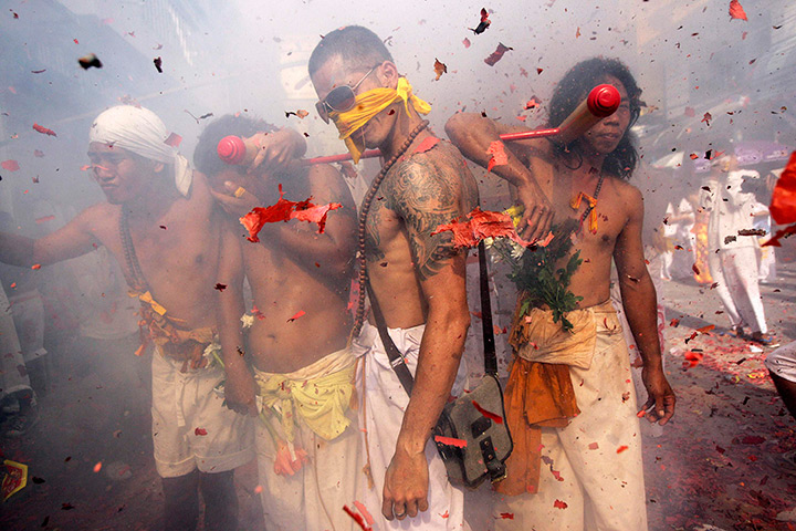 24 hours in pictures: Devotees of the Bang Neow Chinese Shrine stand amidst firecrackers, Phuket