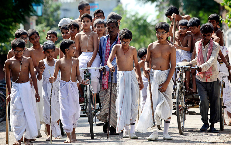 24 hours in pictures: Schoolchildren dressed as Mahatma Gandhi ahead of Gandhi Jayanti