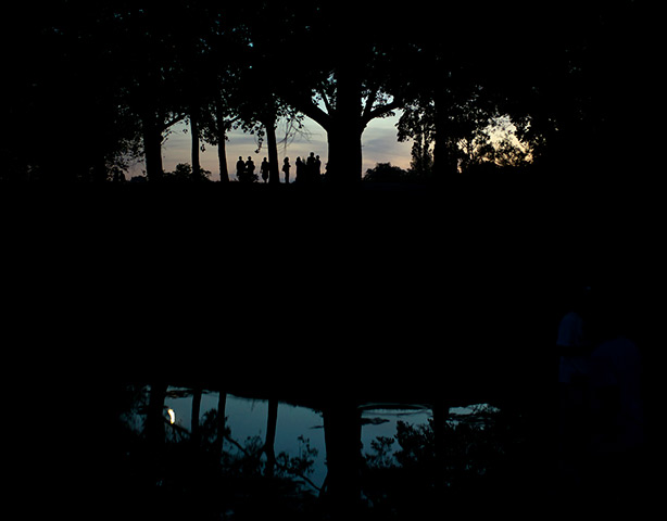 UK October heatwave: People are silhouetted in warm evening in Hampstead Heath