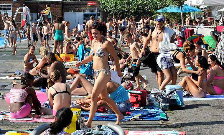 UK October heatwave: Sunbathers enjoy the sun and open air pool at Brockwell Park