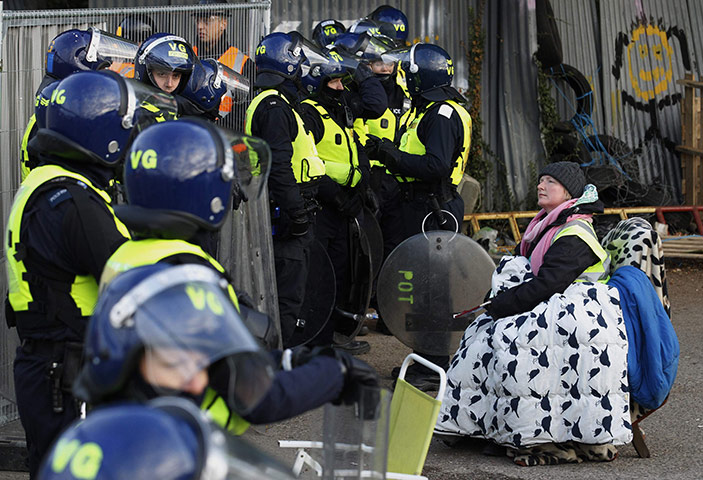 Dale Farm: a campaigner in front of a cordon of riot police