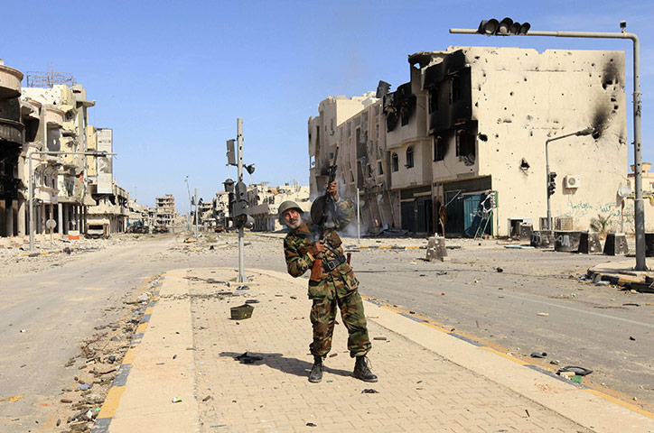 Sirte falls: An anti-Gaddafi fighter celebrates the fall of Sirte