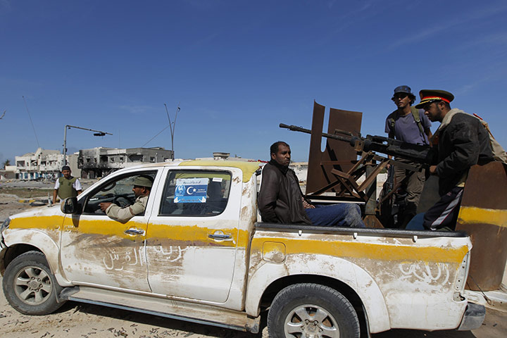 Sirte falls: A Gaddafi loyalist is taken prisoner by anti-Gaddafi fighters