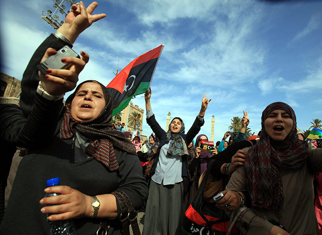 Sirte celebrations: Libyans wave their new national flag as they celebrate in the streets