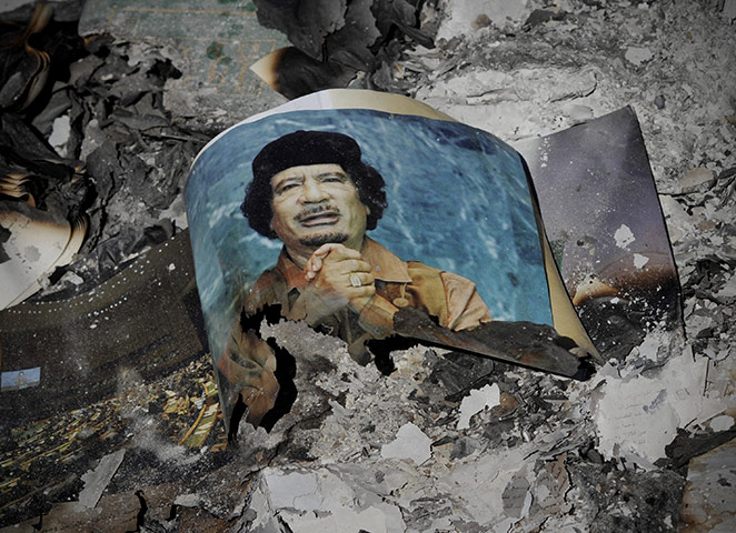 Cult of Gaddafi: A picture of Gaddafi in ashes in downtown Sirte, Libya