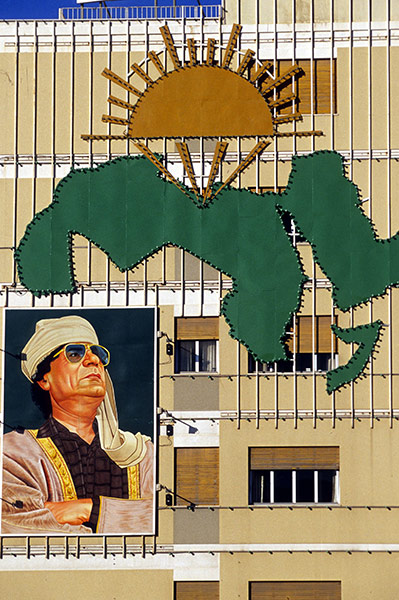 Cult of Gaddafi: A portrait of Gaddafi is displayed on the side of a building in Tripoli