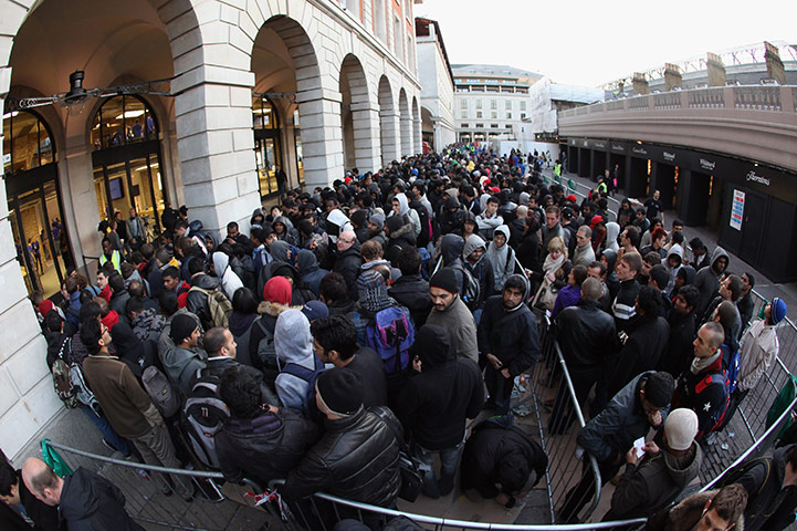 Week in Business: Customers queue outside the Apple store Covent Garden to buy an iPhone 4S
