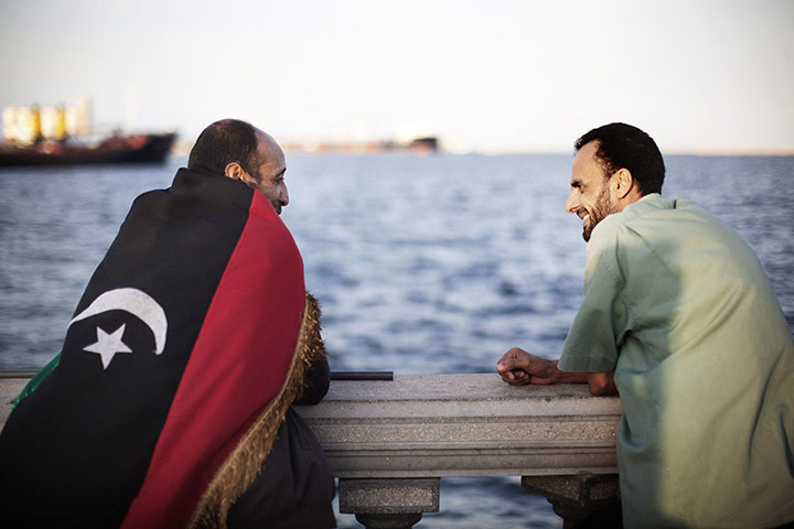 Libya celebrates: A Libyan man wears a national flag during celebrations, Tripoli  