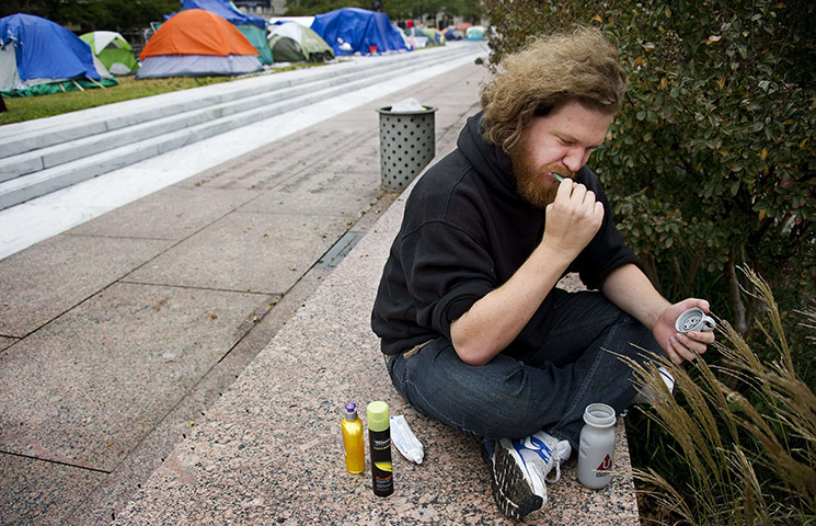 Occupy Protests: Washington, DC: Demonstrator Jordan Brinkman brushes his teeth