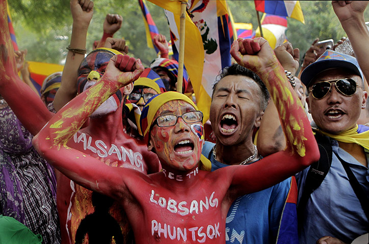 24 hours in pictures: New Delhi, India: Exiled Tibetans shout slogans during a protest march