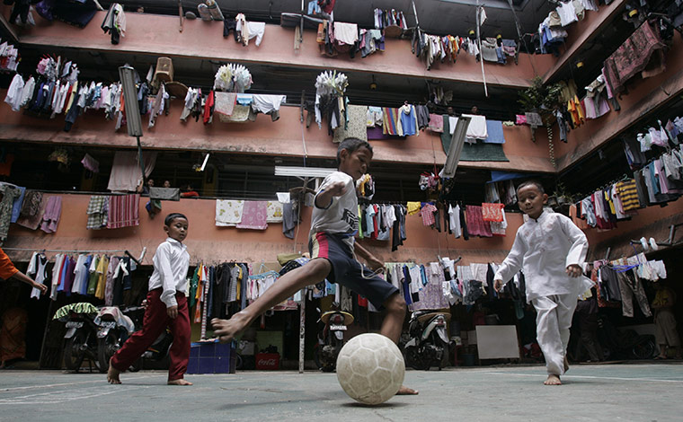 24 Hours: Children play football in a slum area in Jakarta