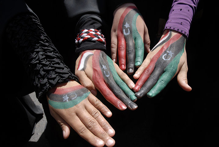 24 Hours: Female protesters display their hands during a rally in Sanaa