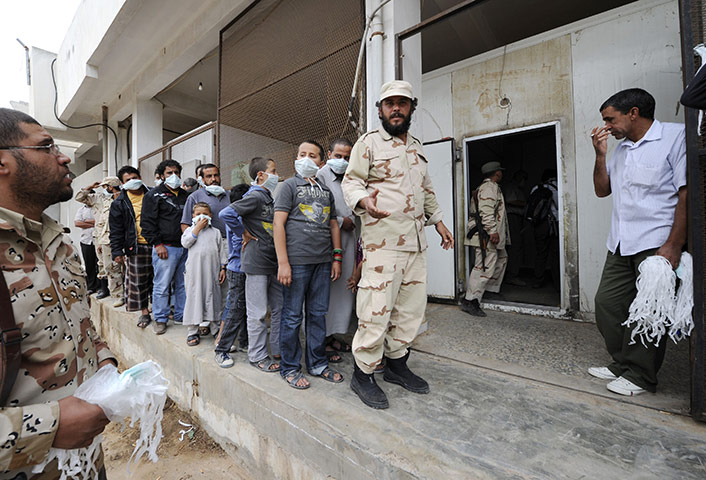 Libya after Gaddafi: Libyan men and children queue to see body of Muammar Gaddafi, Misrata