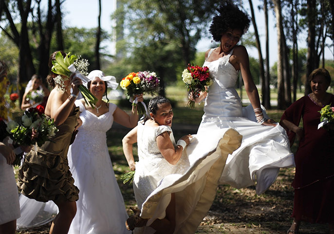 24 hours: Sao Paulo, Brazil: Women in wedding gowns jump during the Parade of Brides