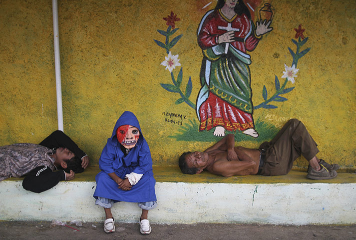 24 hours: Masaya, Nicaragua: A child dressed as a devil at a celebration