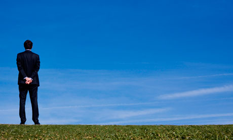 Business man outdoors looking into the distance