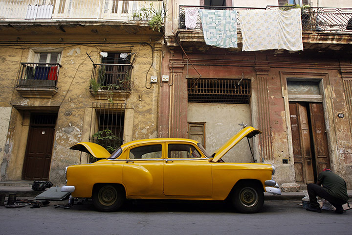 Chevrolet: A man fixes his 1954 Chevrolet in Havana, Cuba