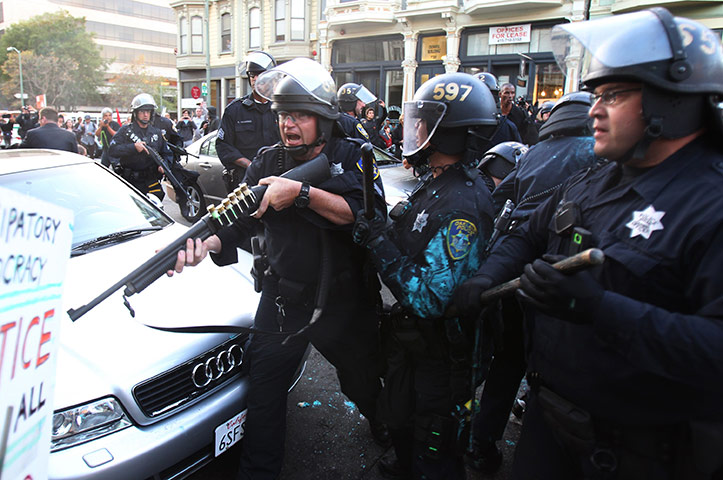 occupy oakland clashes: Police officers with firearms confront protestors