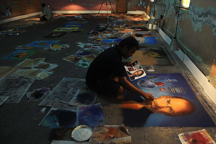 Diwali festival of lights: An Indian artist makes finishing touches to a rangoli depicting Steve Jobs