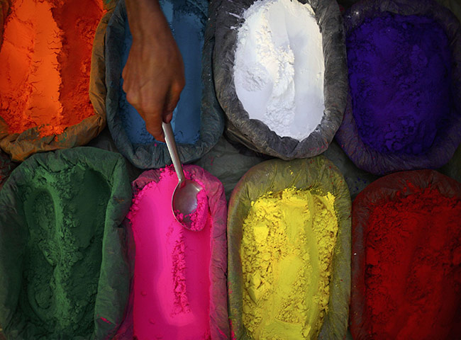 Diwali festival of lights: A vendor scoops vermilion powder used during the Tihar festival Kathmandu