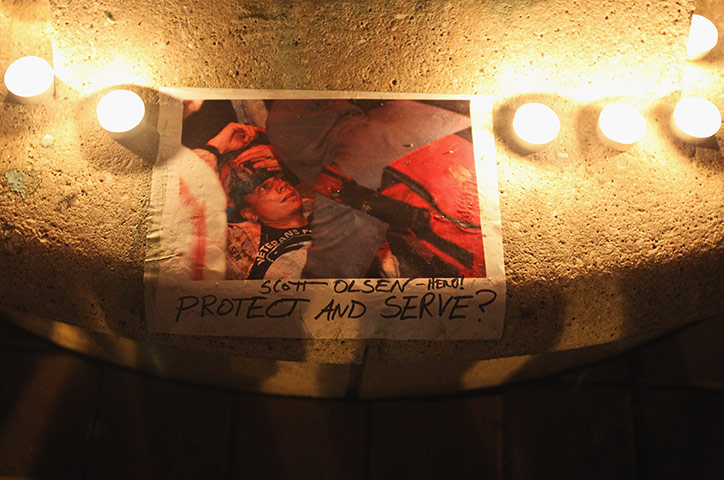 A picture of Scott Olsen is surrounded by candles  via guardian.co.uk