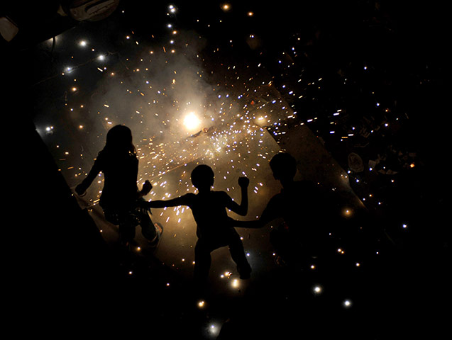 24 hours in pictures: New Delhi, India: Children light fireworks for Diwali