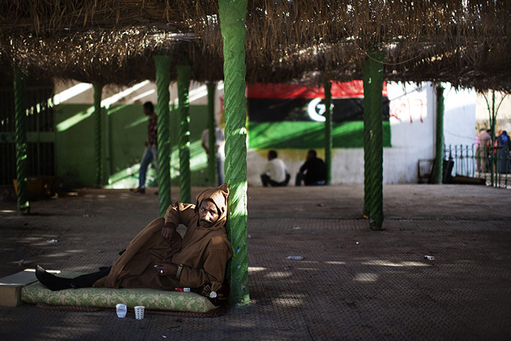 24 hours in pictures: Tripoli, Libya: A man relaxes on a mattress outside a mosque