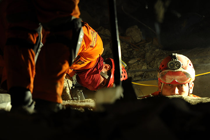 24 hours in pictures: Ercis, Turkey: Rescuers work on a collapsed building