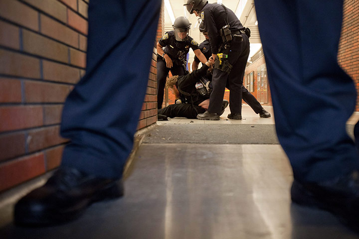 Occupy Oakland protest: A protester is taken down by BART (Bay Area Rapid Transmit) police