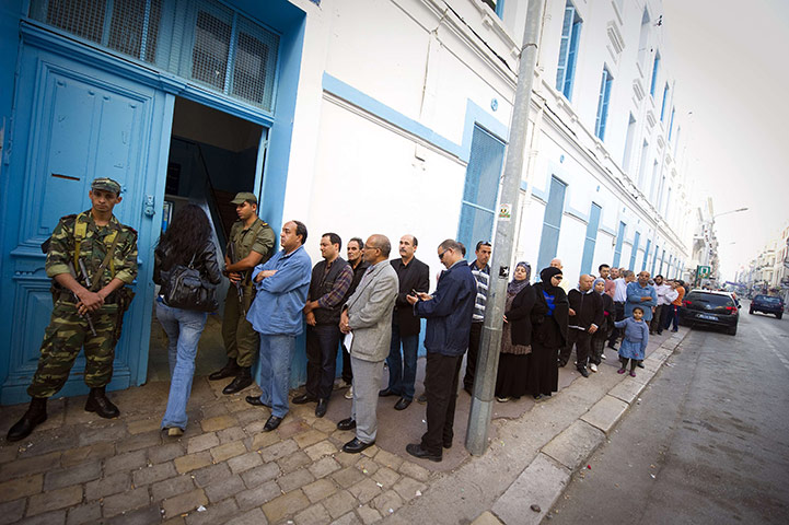 Tunisia elections: 23 October: People queue in front of a polling station in Tunis