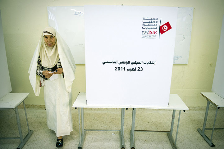 Tunisia elections: 23 October: A woman leaves a ballot booth on at a polling station in Tunis