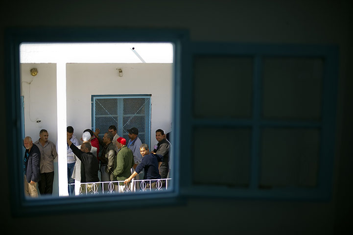 Tunisia elections: 23 October: People wait to vote in a polling station in Ettadhamen