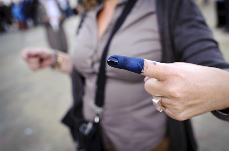 Tunisia elections: 23 October: A woman with an inked finger after voting