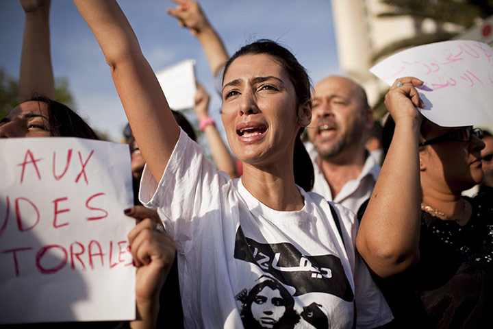 Tunisia elections: 25 October: People shout slogans during a demonstration