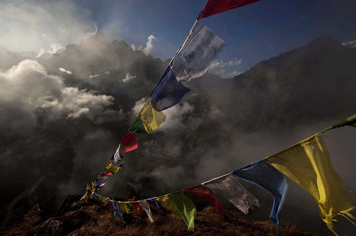 24 Hours: Tengboche, Nepal: Tibetan Buddhist prayer flags flutter in the Himalayas