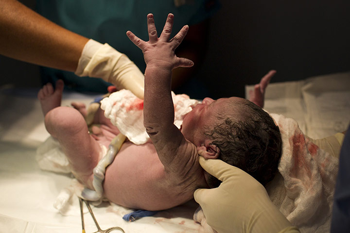 24 Hours: Caracas, Venezuela: A newborn baby is cleaned minutes after being born