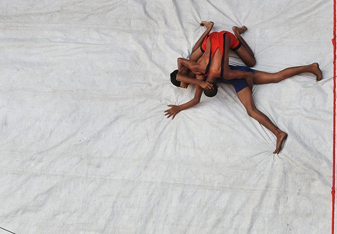 24 Hours: Kolkata, India: Men participate in a friendly wrestling match for Diwali
