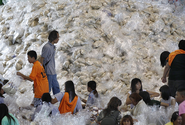 bangkok flooding: Volunteers package donated rice for flood victims