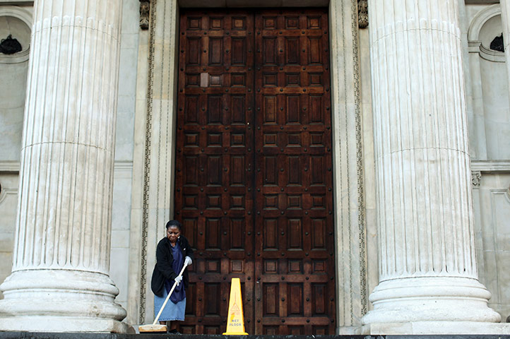 St Paul's reopens: Workers clean the steps of the Cathedral