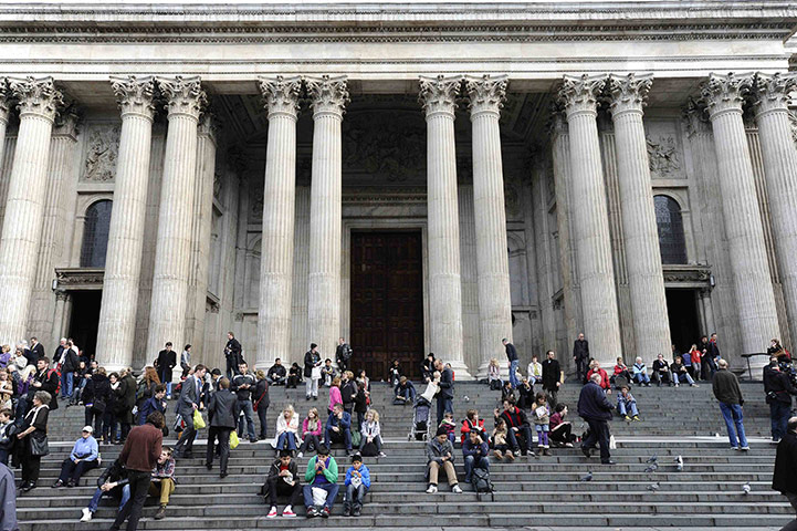 St Paul's Cathedral: People sit on the steps of St Paul's