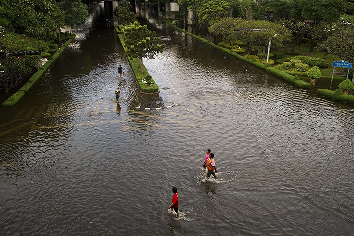 Bangkok: People walk in the floodwaters, next to the Chao Praya river in Bangkok