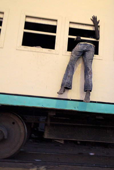 24 hours: A South Sudanese man crawls through a window into a train