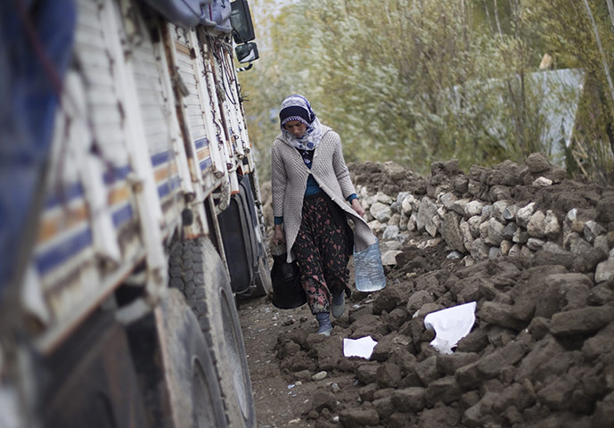24 hours: An earthquake survivor carries clean water in Guvecli village