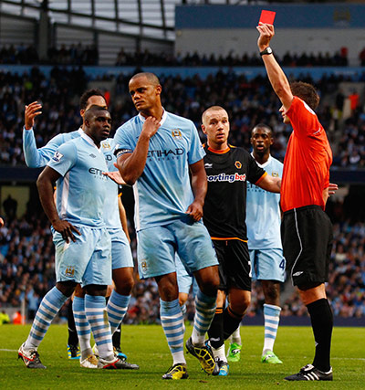 Premier League roundup: Vincent Kompany is shown a red card by the referee