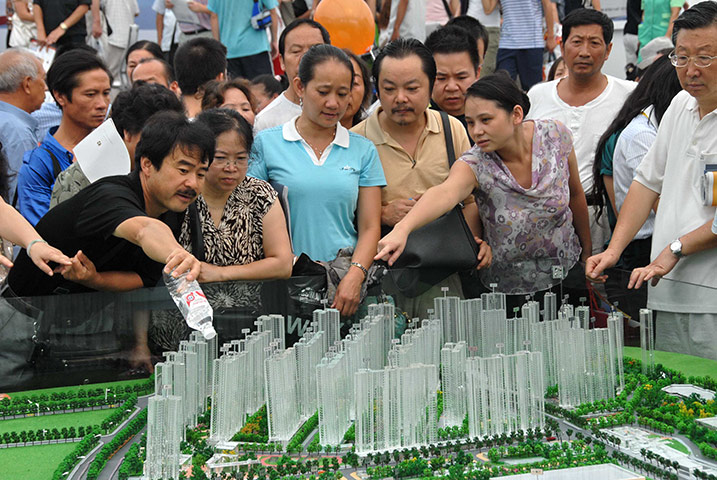 Guiyang urbanisation: Consumers look at models during a housing fair in Guiyang
