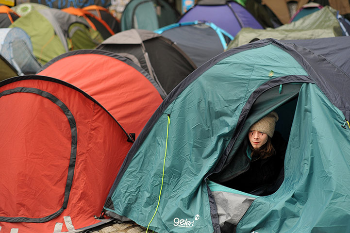 Occupy London protests: A protester from the Occupy London protests looks from his tent 
