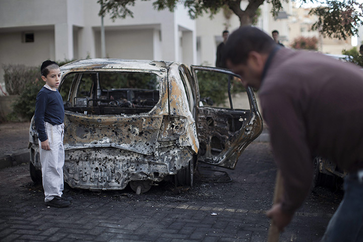 24 hours: Ashdod, Israel: Cleaning up debris from a rocket from Gaza