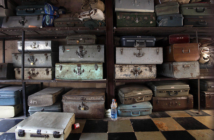 24 hours: Mumbai, India: Tin boxes containing belongings of people sharing one room 